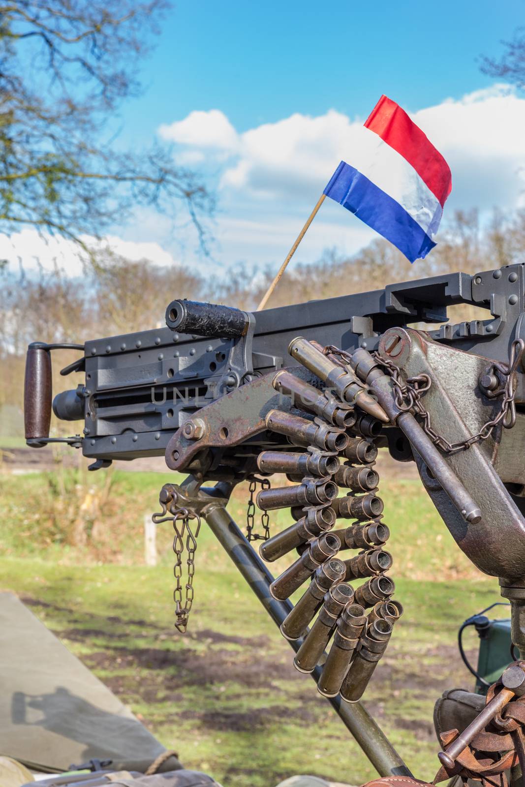 Military machine gun with bullets and dutch flag