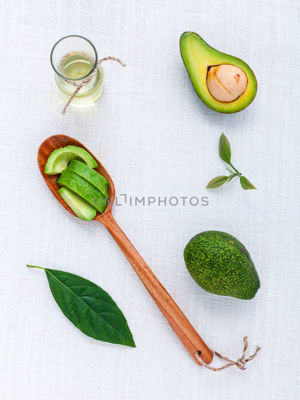 Avocado oil on the white table background clean and healthy conc by kerdkanno