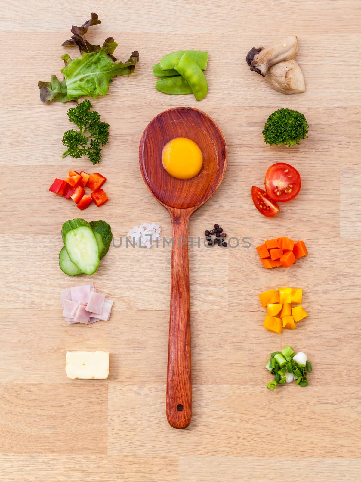 Ingredients of homemade omelet on wooden panel.