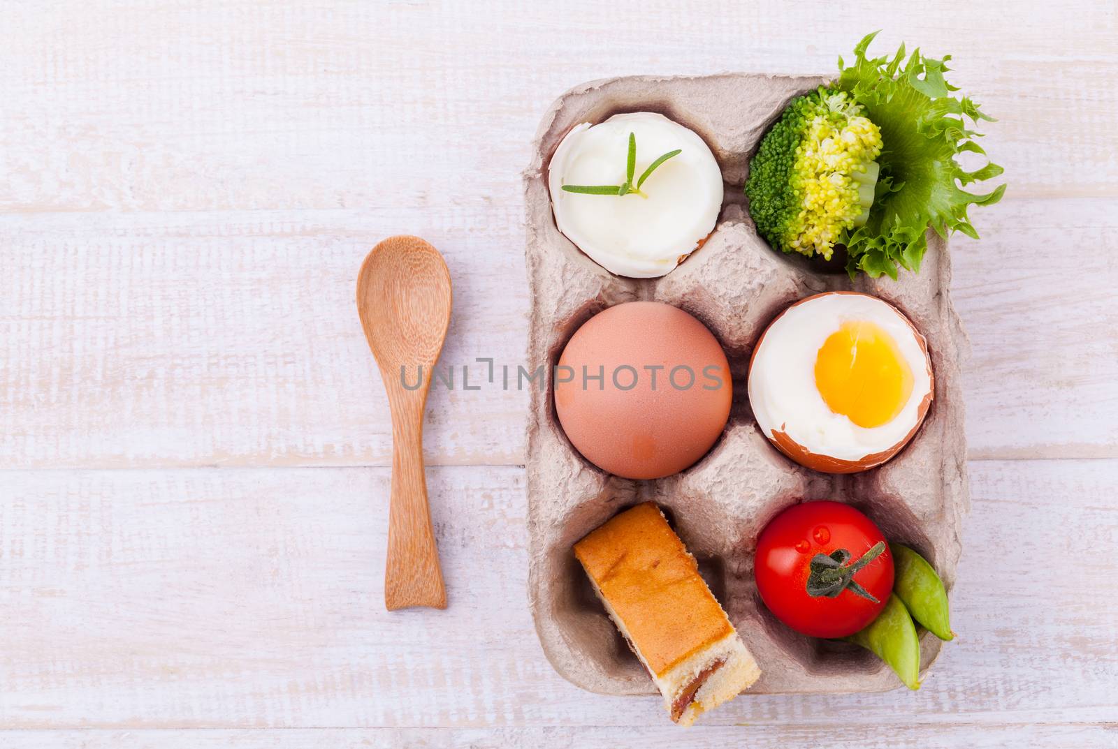 Boiled eggs for breakfast on wooden table.