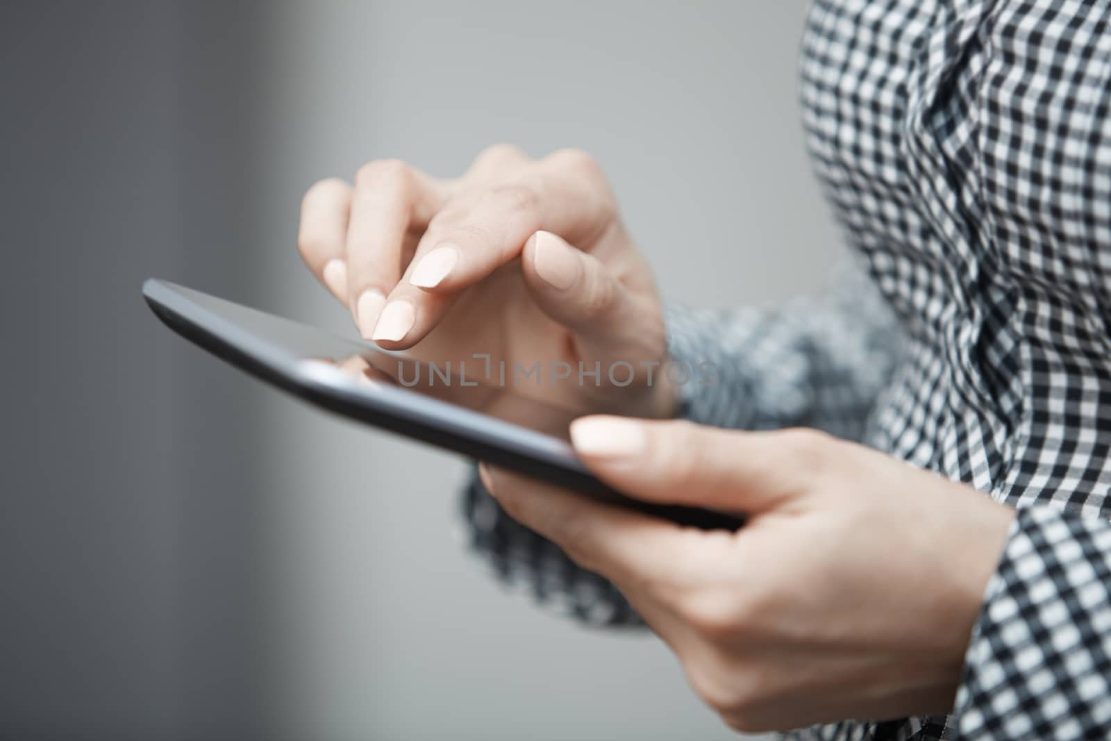 Womanworking with digital tablet. Close-up horizontal photo