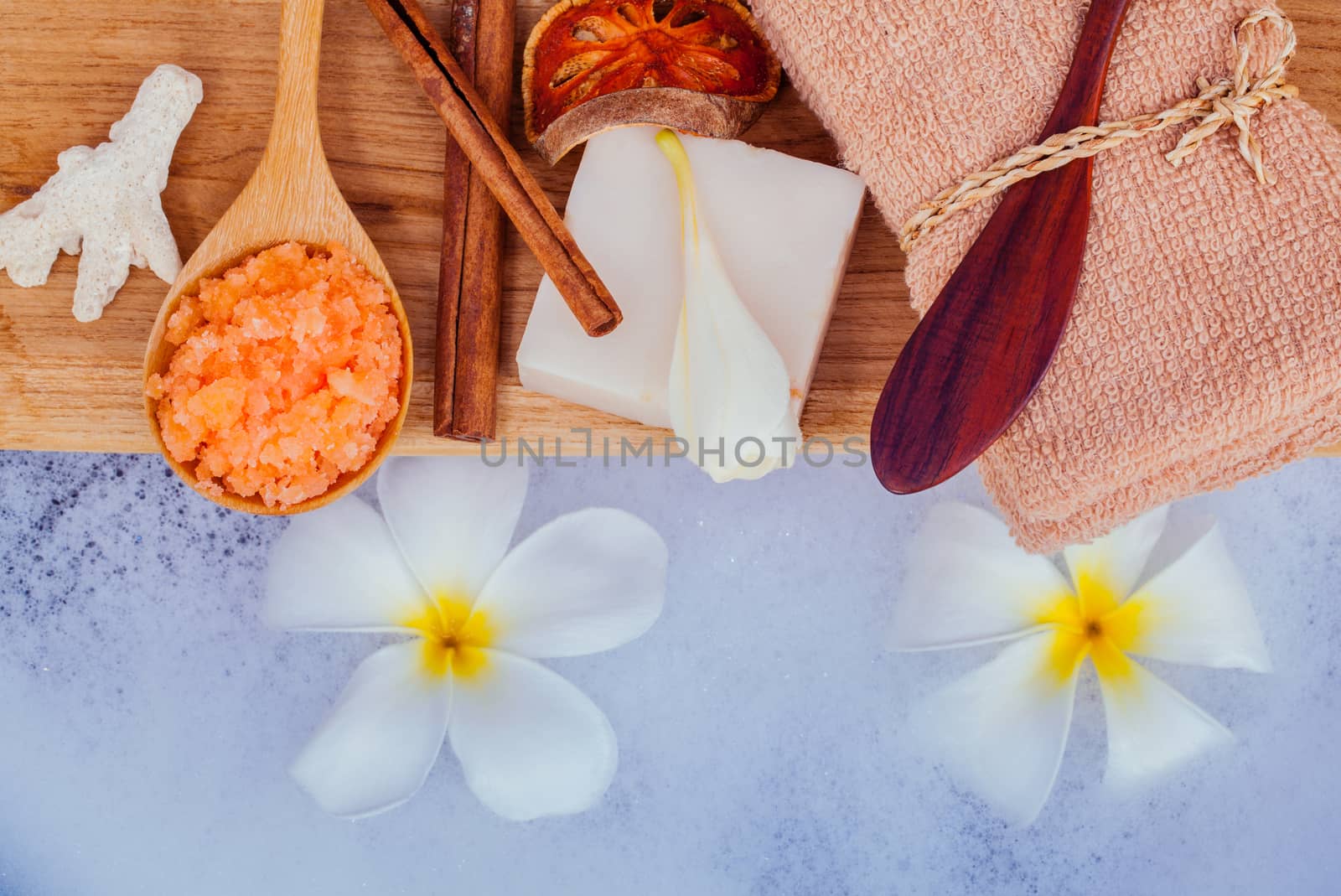 Spa and wellness treatment setup on wooden panel. by kerdkanno