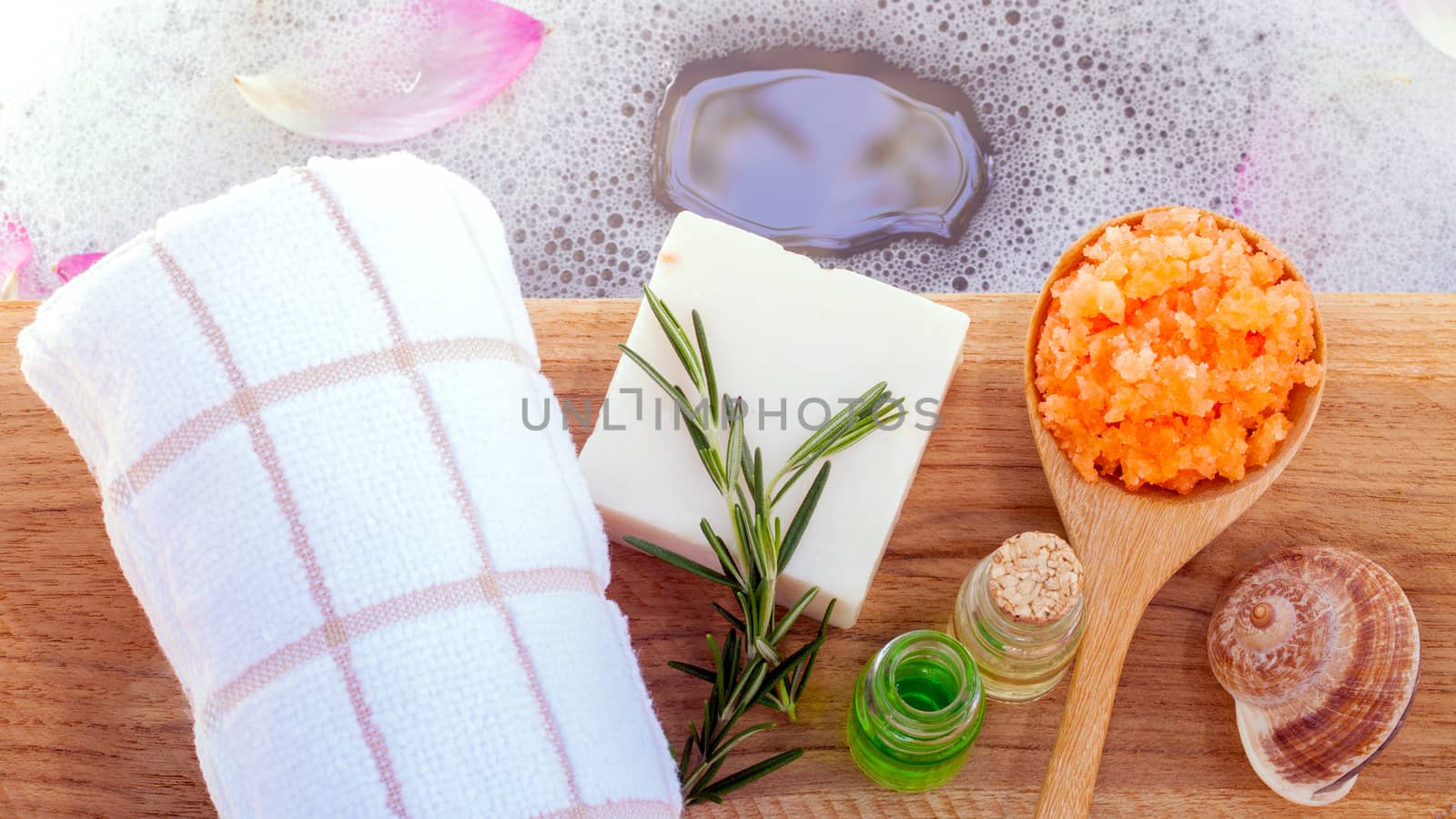 Spa and wellness treatment setup on wooden panel.