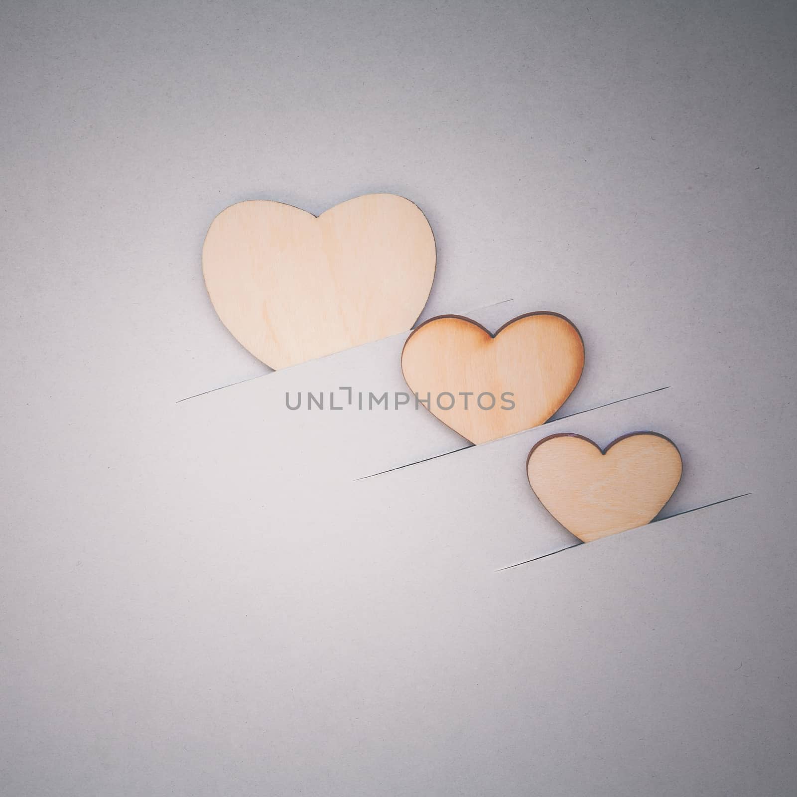 The wooden hearts on cardboard background. - Concept for love an by kerdkanno