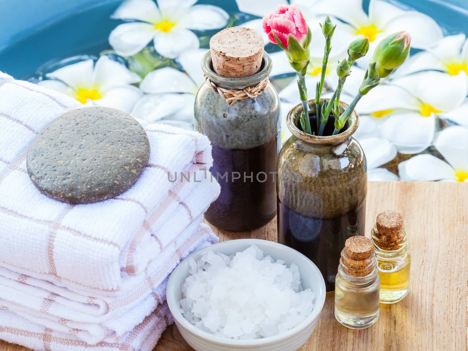 Spa and wellness treatment setup on wooden panel. by kerdkanno