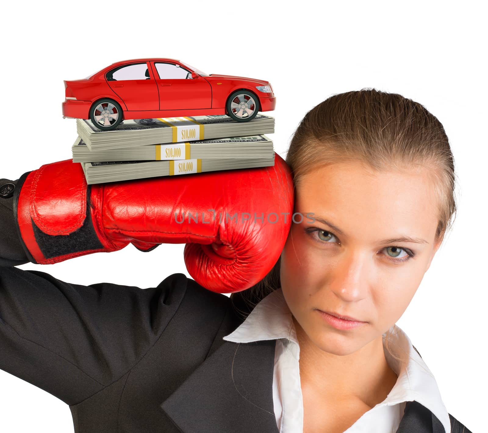 Businesswoman in boxing gloves with red car and money looking at camera on isolated white background