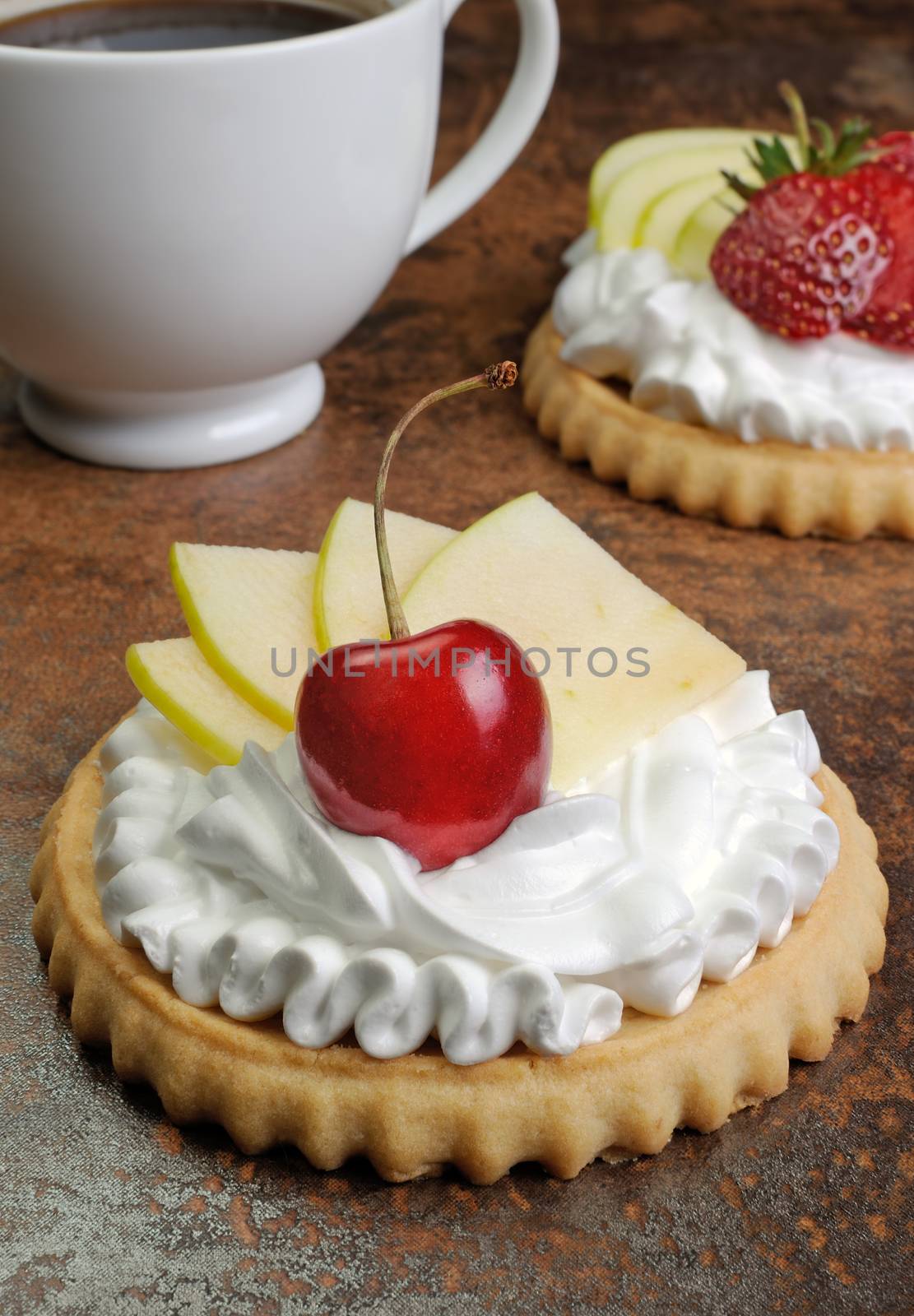 Tartlets with whipped cream cherries, apple and a cup of coffee