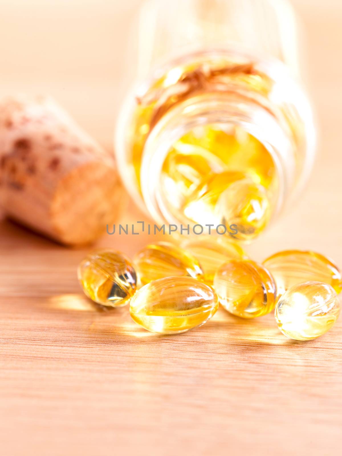 Cod liver oil capsules  on wooden panel .