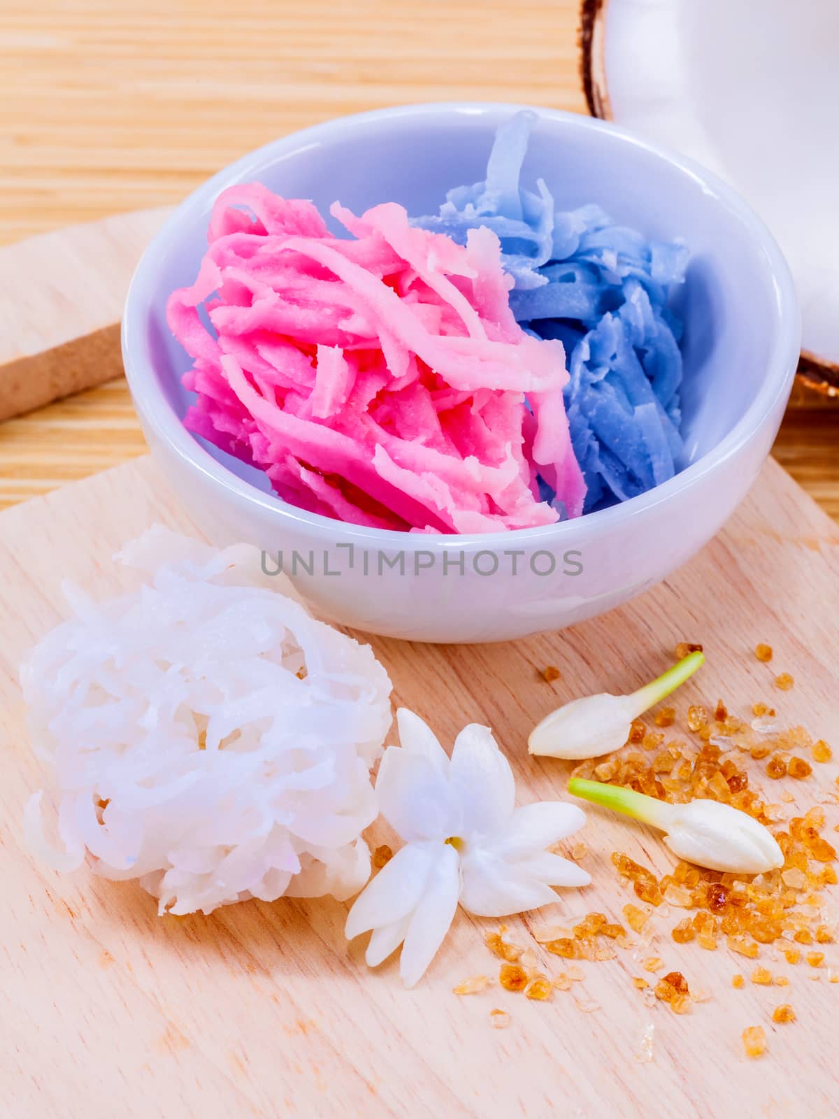 A colorful traditional coconut dessert made from grated coconut and sugar .