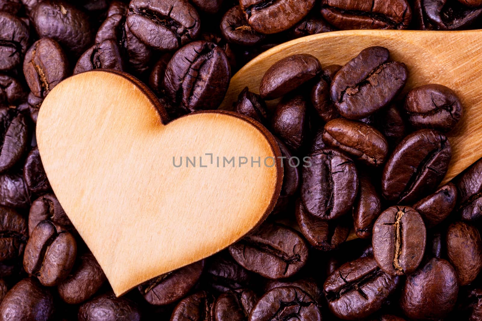 Coffee beans with wooden shape of heart. - Concept for love coff by kerdkanno