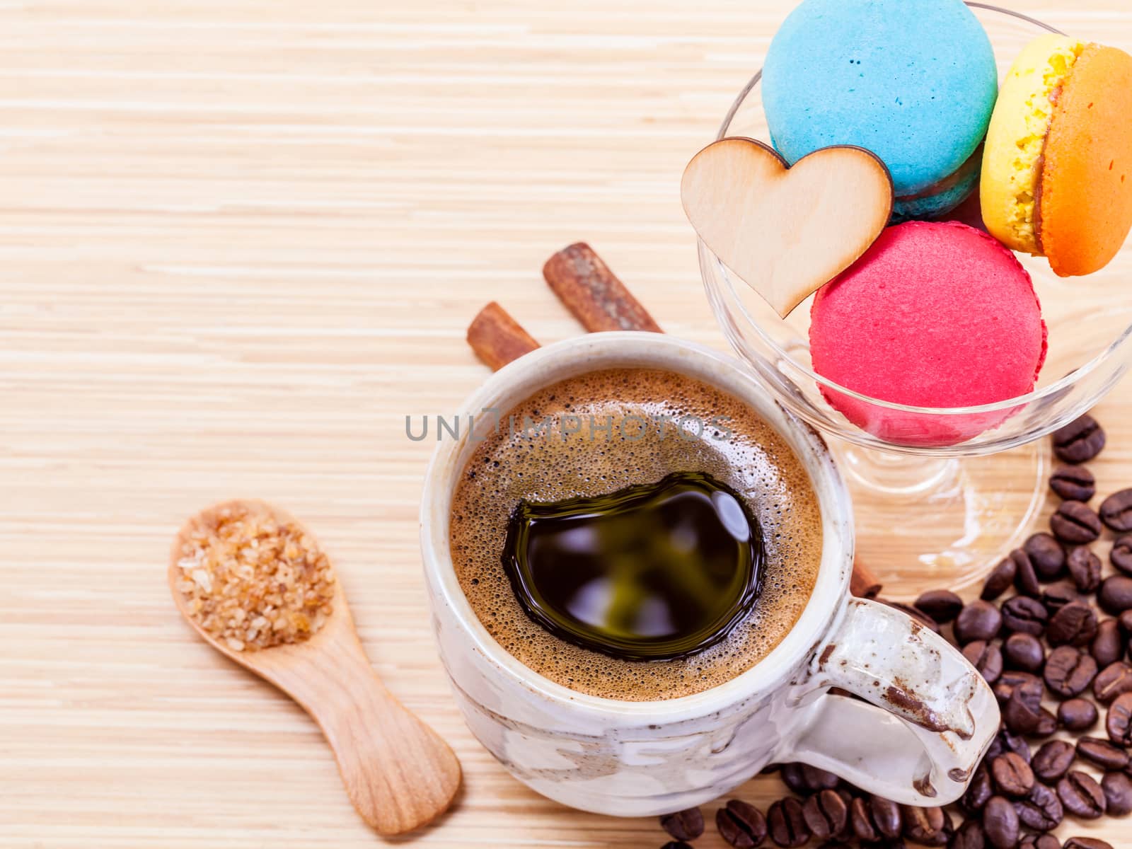 French colourful macaroons and a cup of coffee. - Macro shot wit by kerdkanno