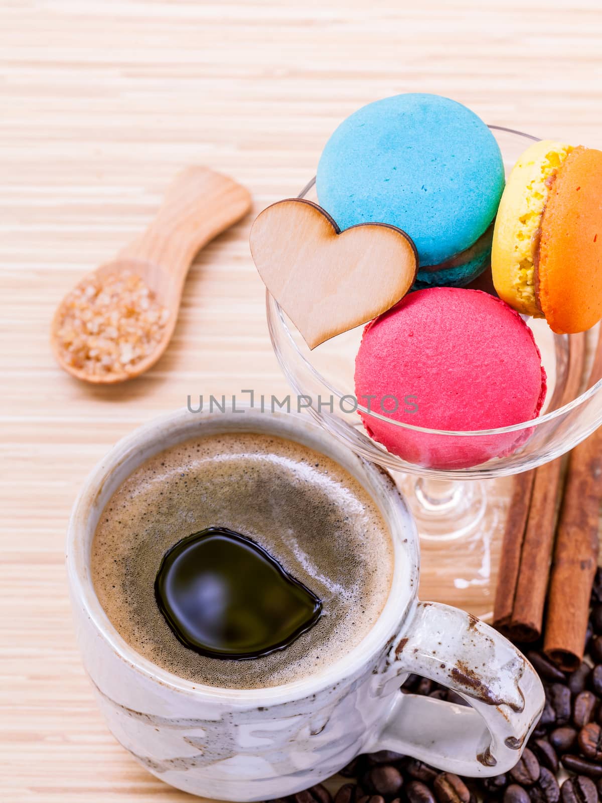 French colourful macaroons and a cup of coffee. - Macro shot with copy space.