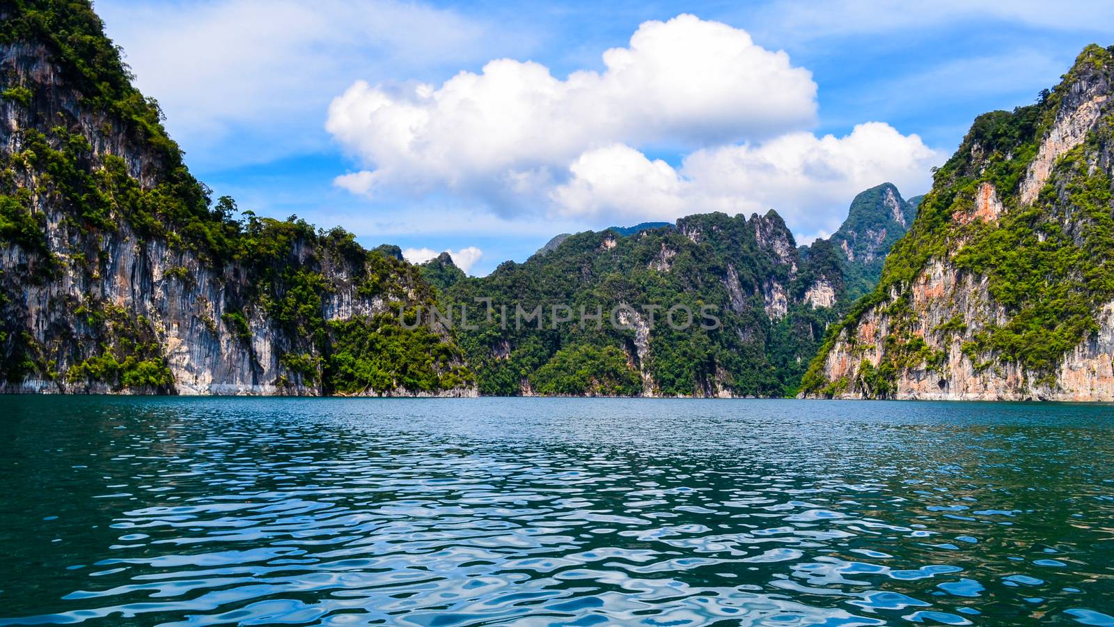 Beautiful scene Blue clear water with rock mountain at Ratchaprapa Dam, Suratthani, Thailand