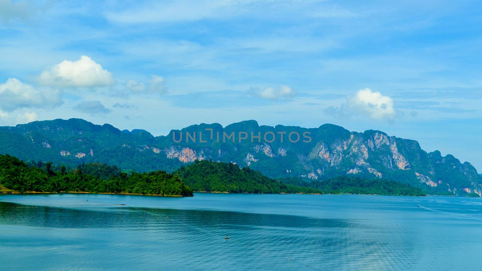 Beautiful scene Blue clear water with rock mountain at Ratchaprapa Dam, Suratthani, Thailand