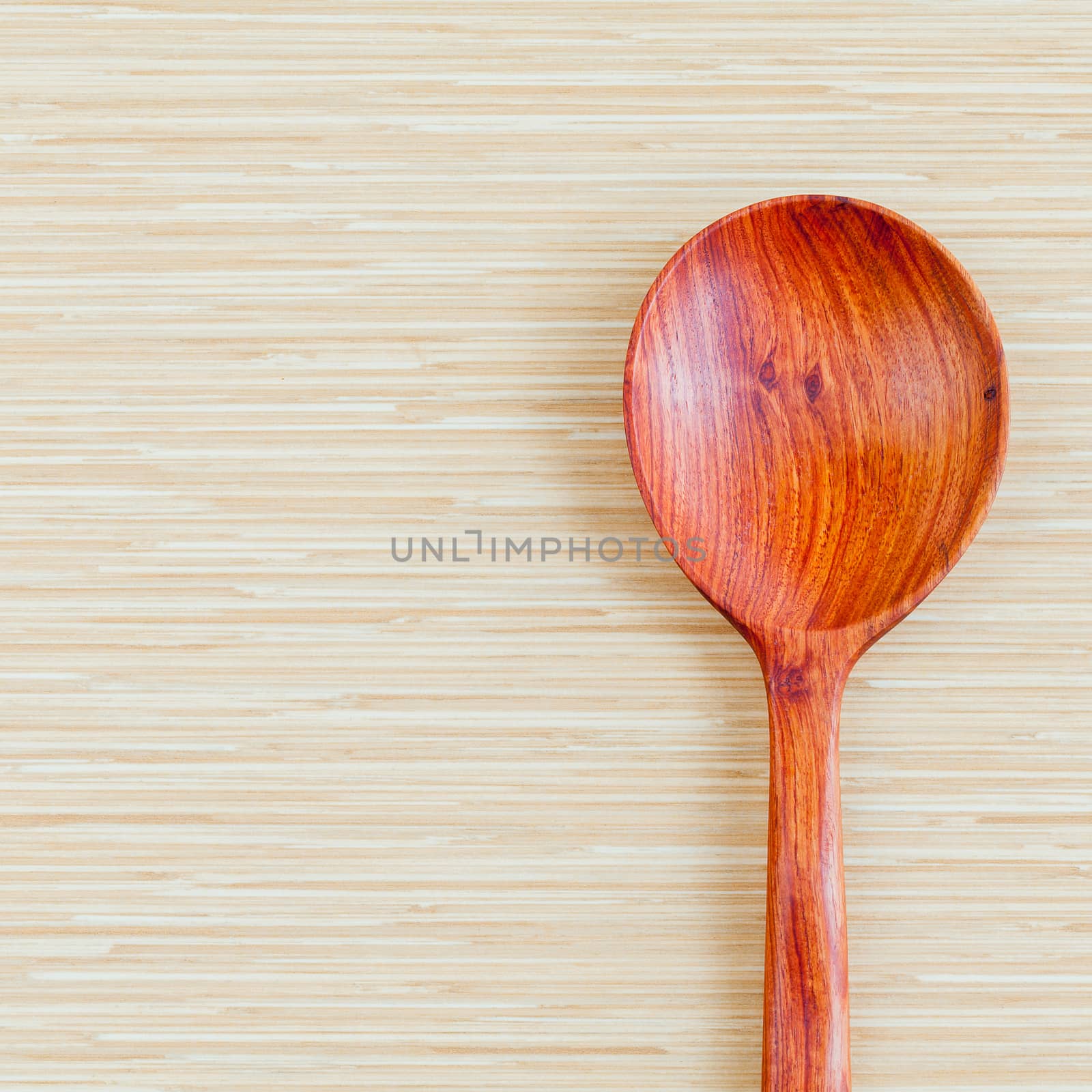 Wooden spoon on wooden background - concept for food and kitchen with copy space.