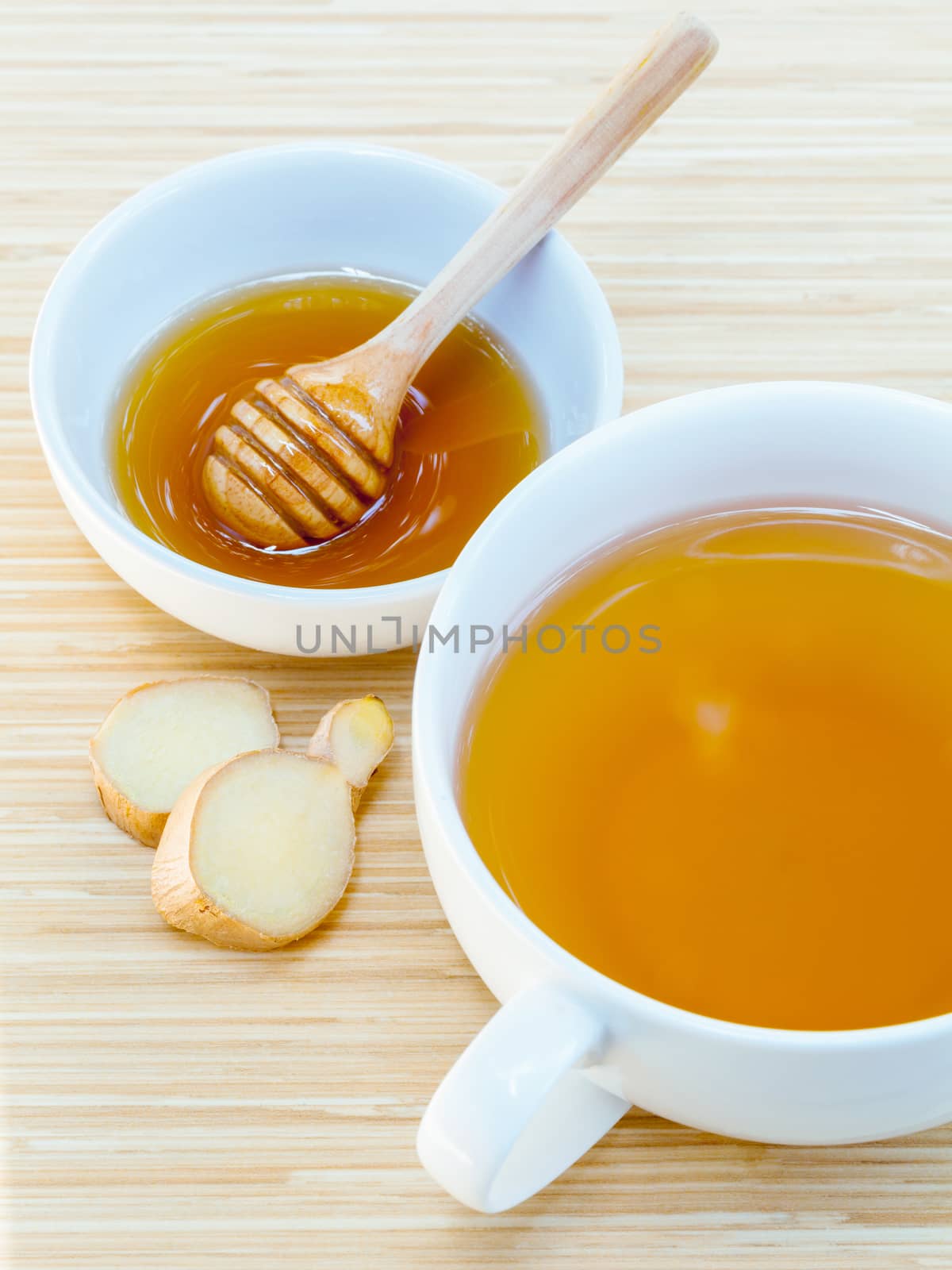 A Cup of ginger tea with honey on wooden background, concept for healthy nutrition.