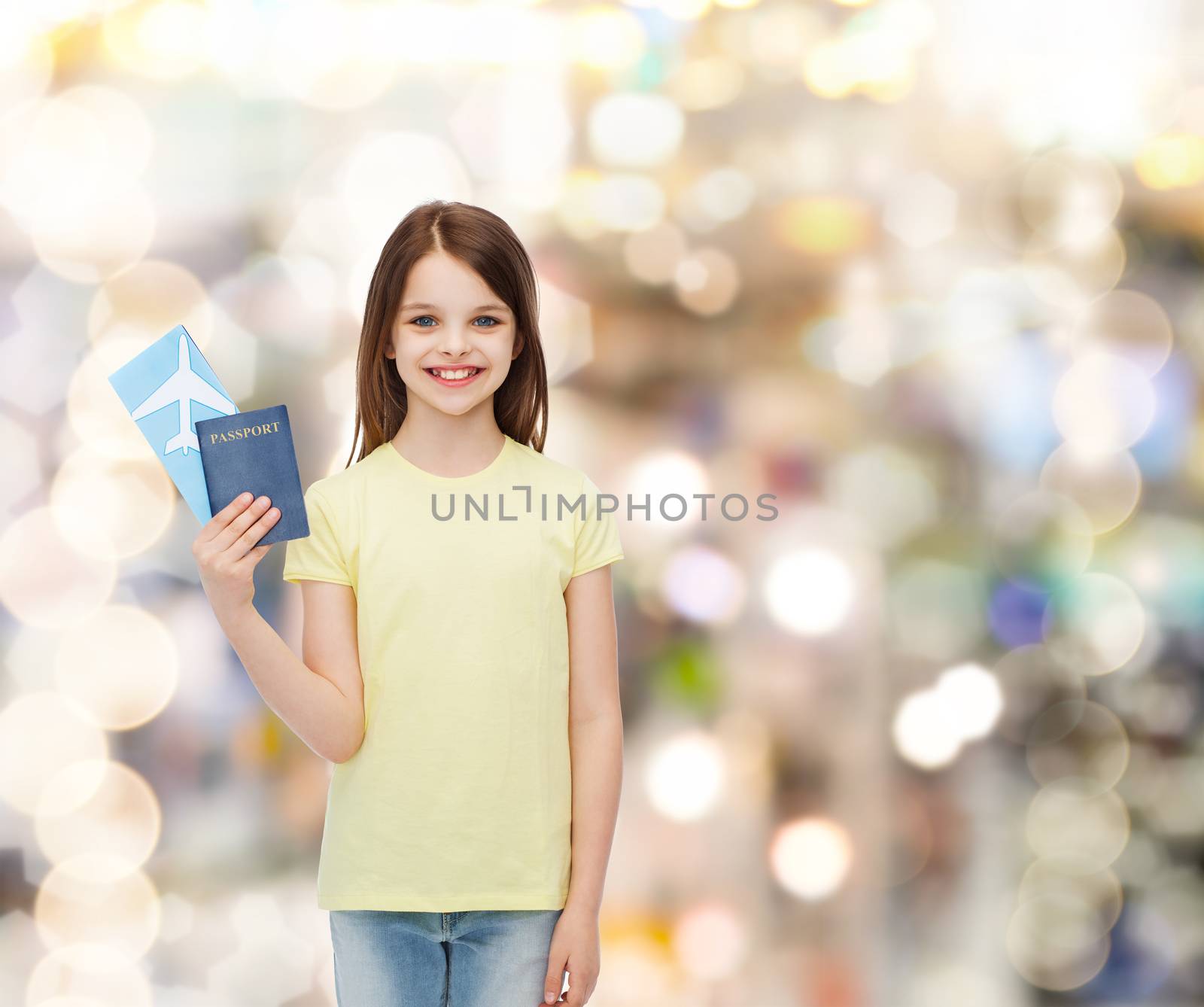 travel, holiday, vacation, childhood and transportation concept - smiling little girl with airplane ticket and passport