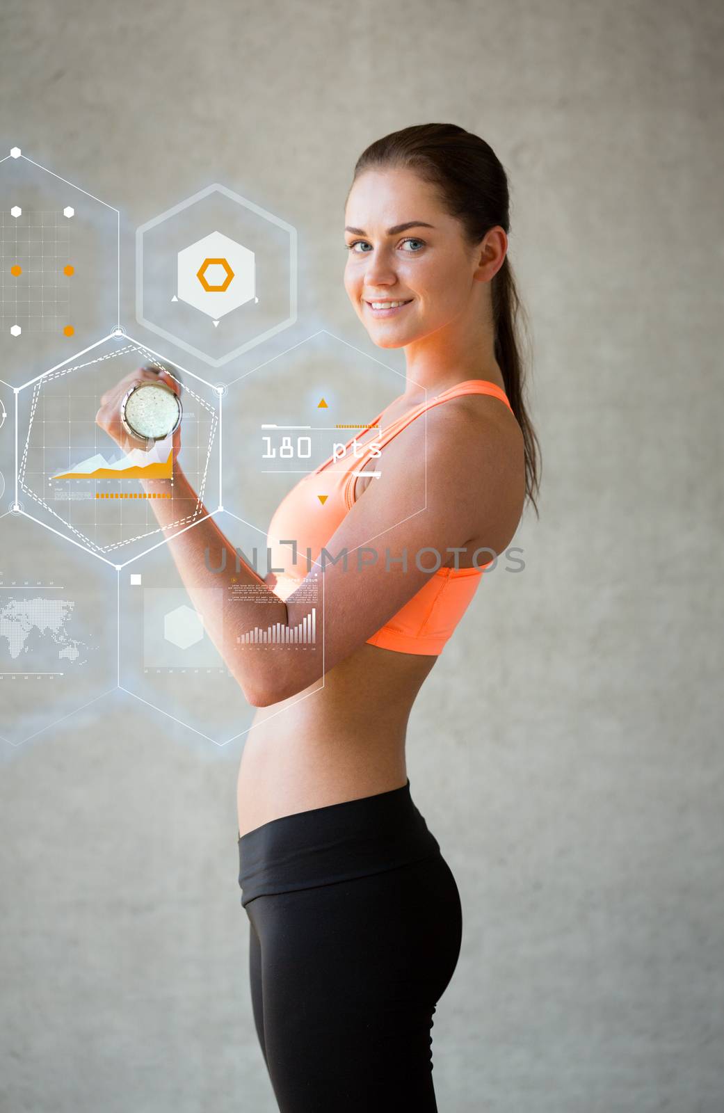 smiling woman with dumbbells in gym by dolgachov