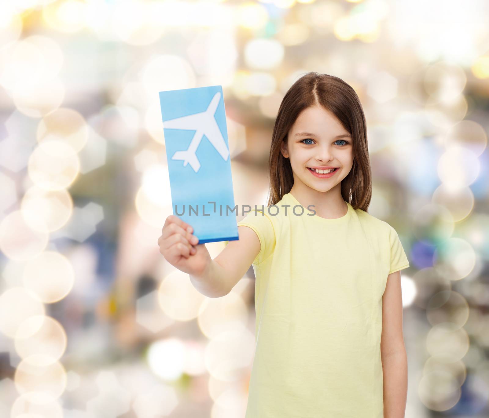 travel, holiday, vacation, childhood and transportation concept - smiling little girl with airplane ticket