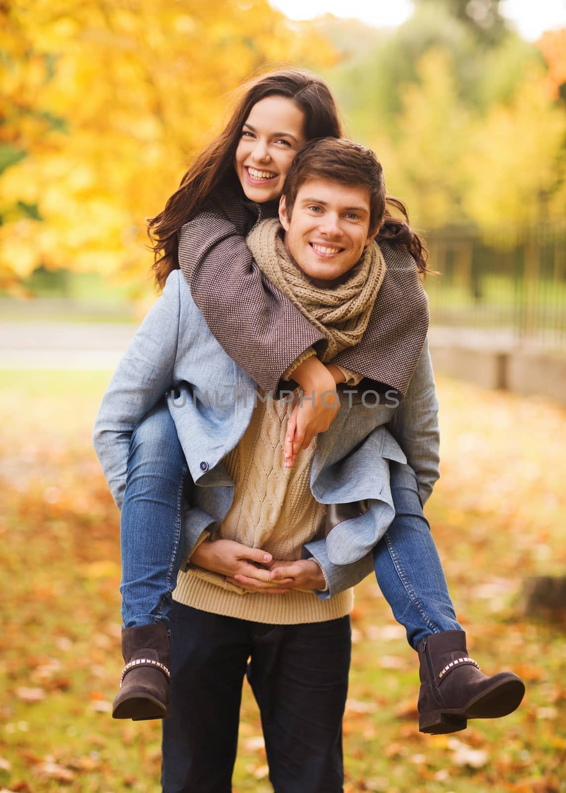 love, relationship, family and people concept - smiling couple hugging in autumn park