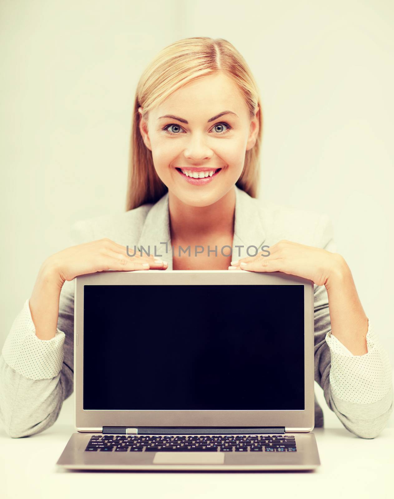smiling woman with laptop pc by dolgachov