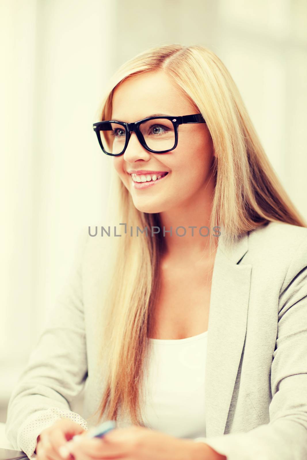 business and education concept - indoor picture of smiling woman with eyeglasses