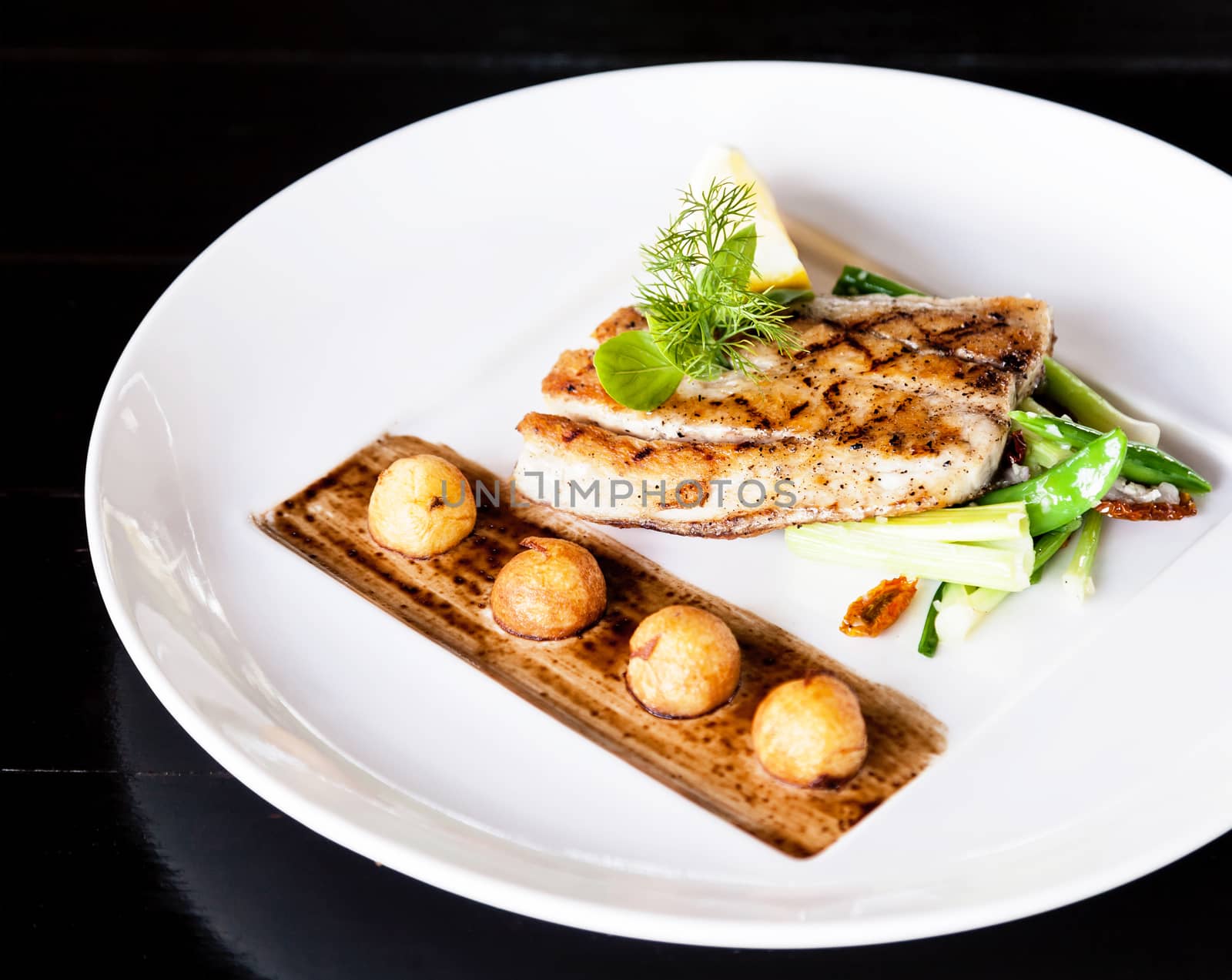 Fillet sea bass with vegetable and potatoes.