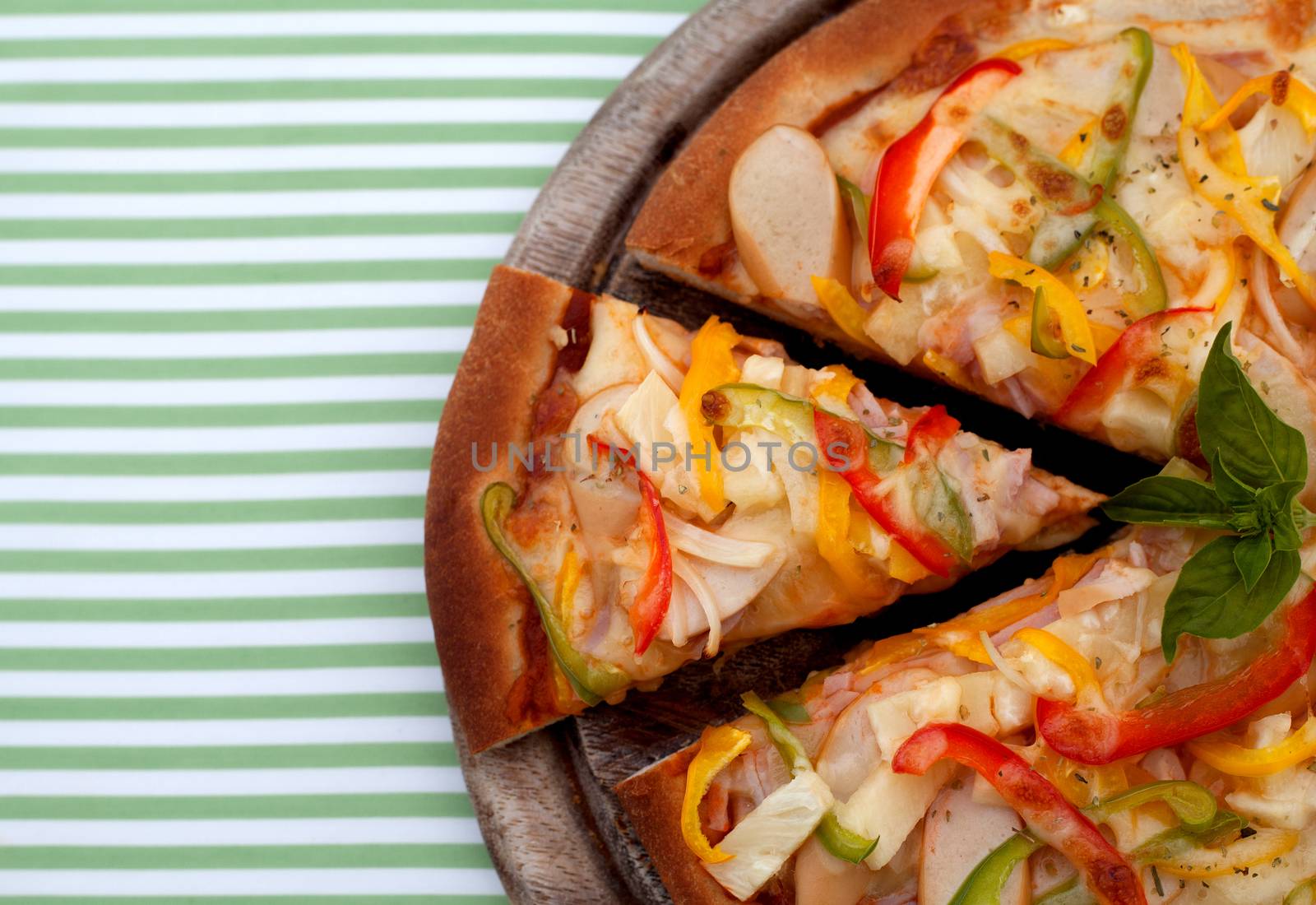 Delicious homemade pizza with ham and vegetables.