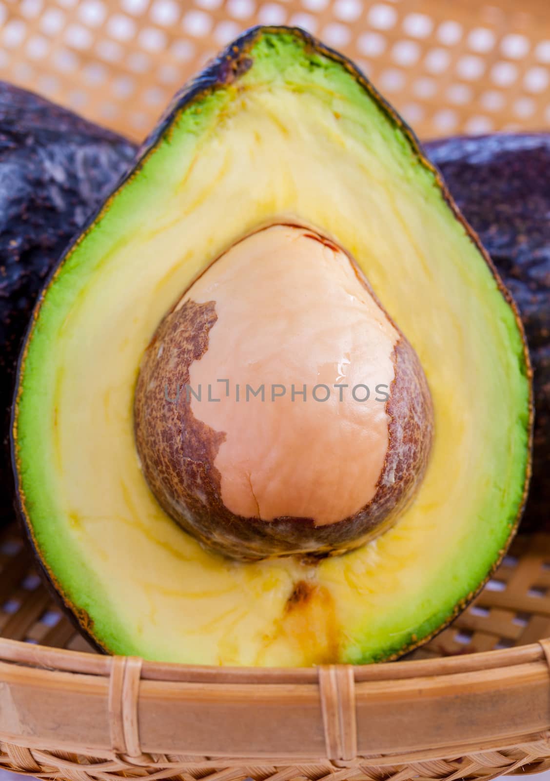 Halved avocado with core isolated on white - in macro shot.