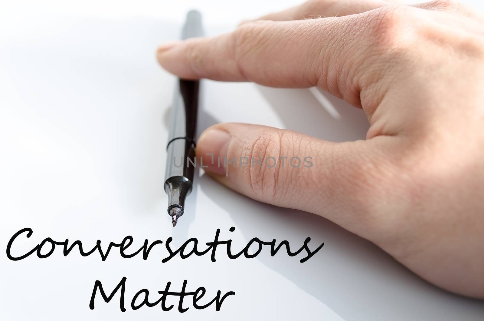 Pen in the hand isolated over white background and text concept