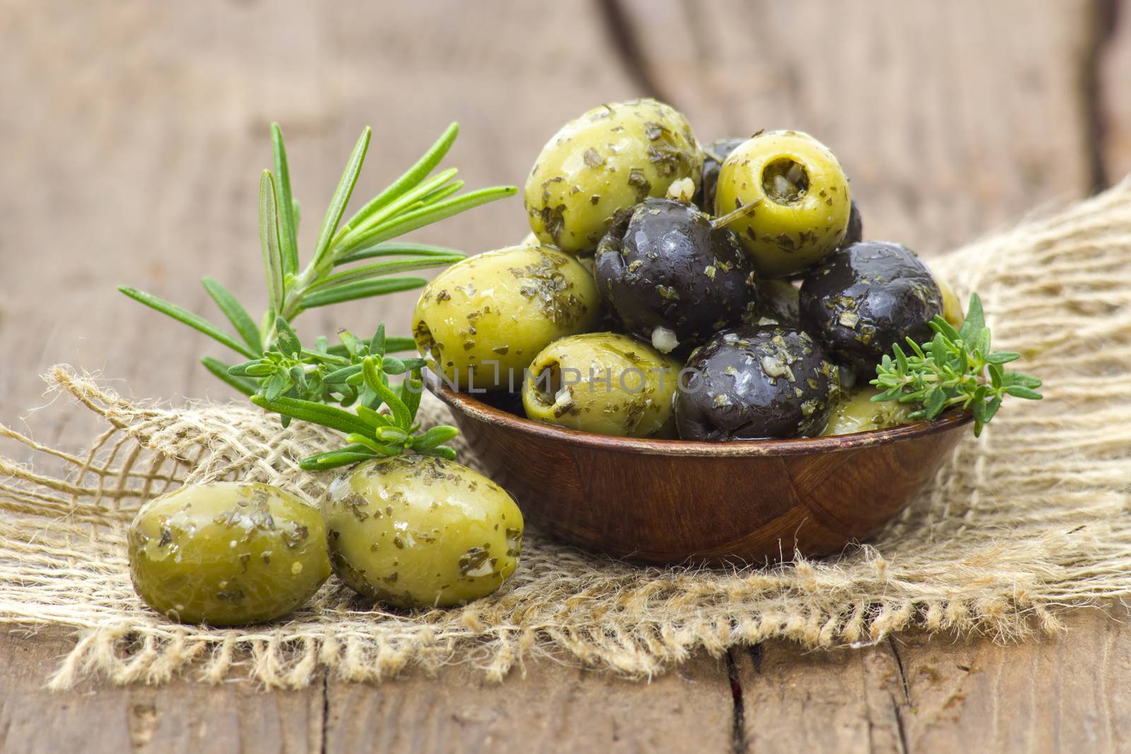black and green olives marinated with garlic and fresh mediterranean herbs