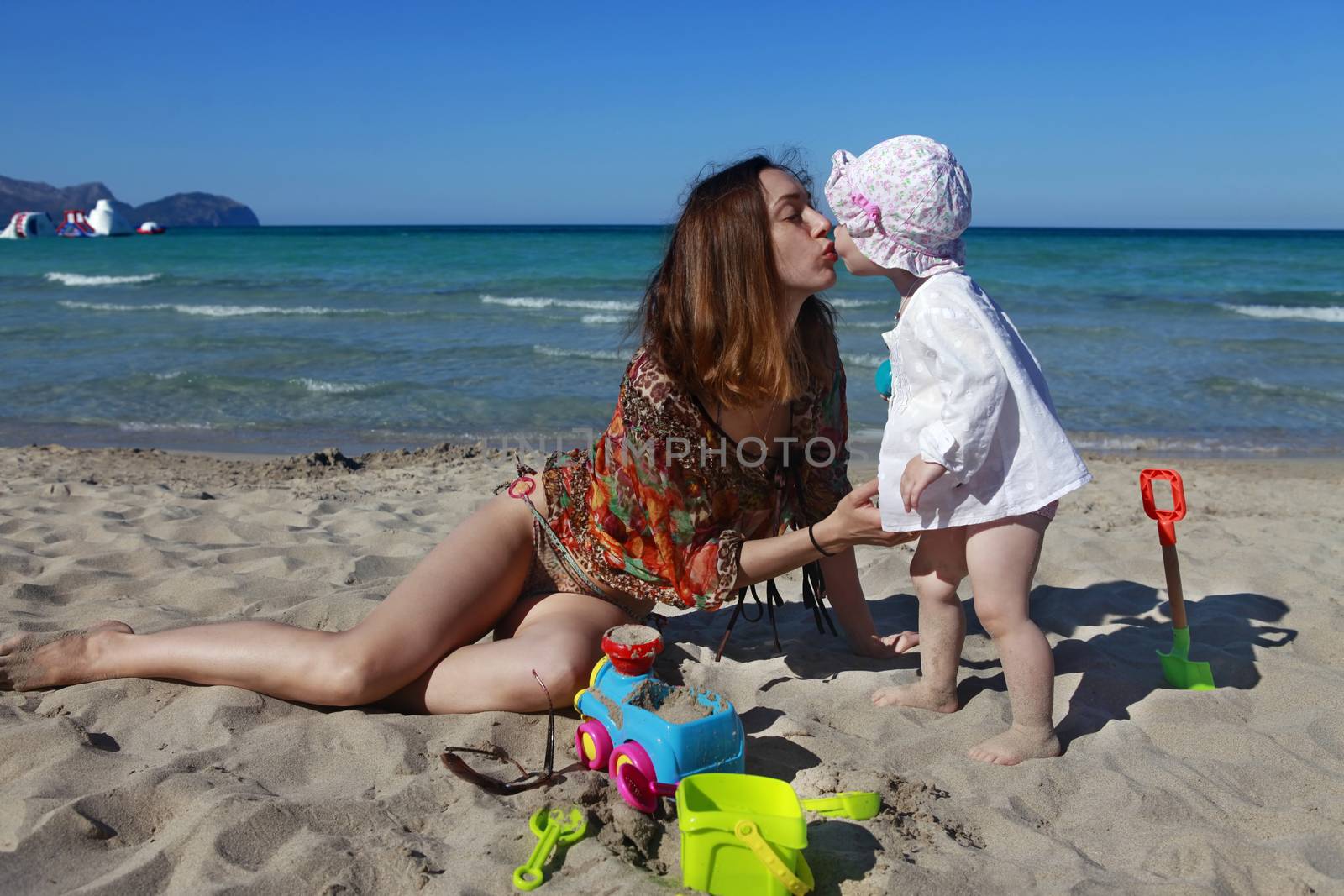 Mother and daughter on the beach by friday