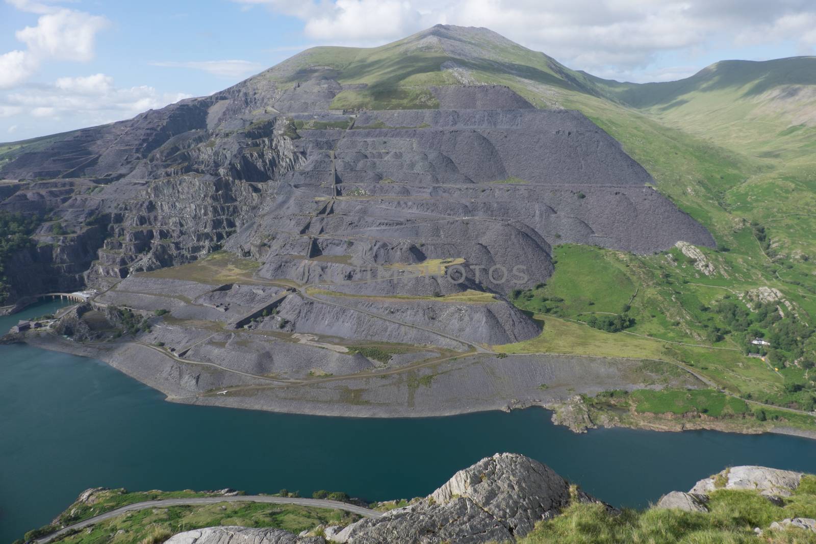A view looking down to Llyn Peris and the expance of the Dinorwic slate quarry workings on the flank of the mountain Elidir Fawr, Llanberis, Gwynedd, Wales, UK.