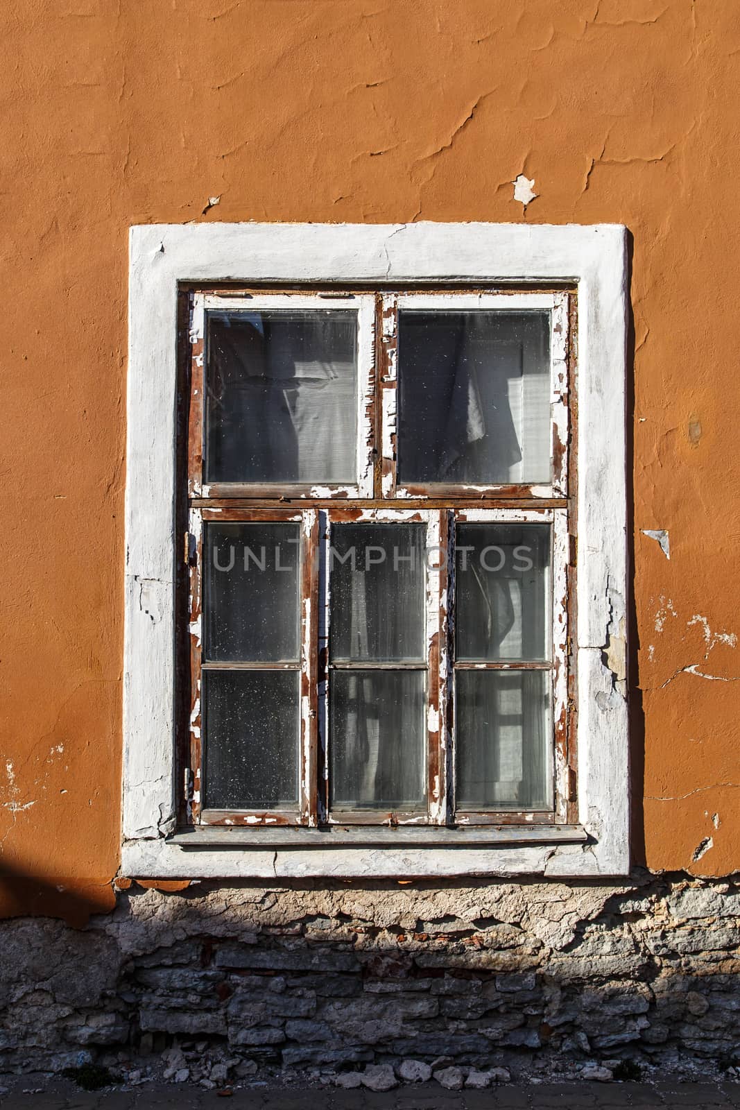 Close up view of brown wooden window of the old orange building.