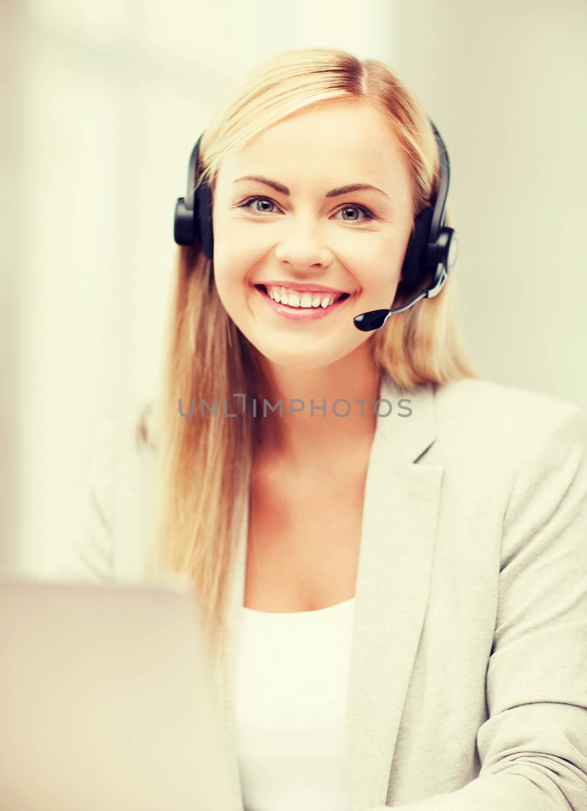 business, call centre and technology concept - female helpline operator with headphones and laptop pc