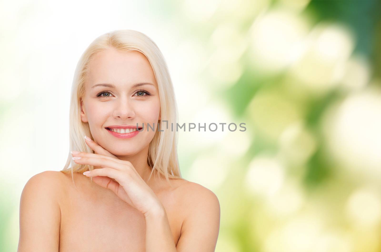 health and beauty concept - face and hands of beautiful woman