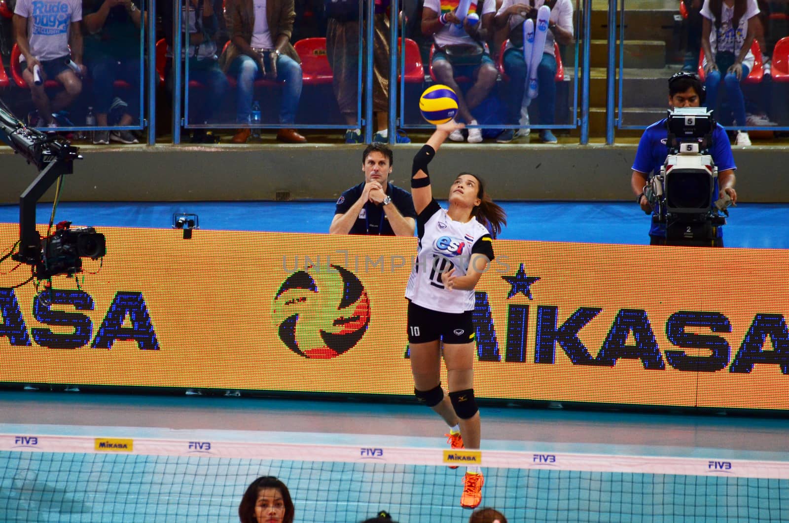 Bangkok, Thailand - July 3, 2015: Wilavan Apinyapong #10 of Thailand serves the ball during the FIVB Volleyball World Grand Prix Thailand and Serbia at Indoor Stadium Huamark on July 3, 2015 in Bangkok, Thailand.