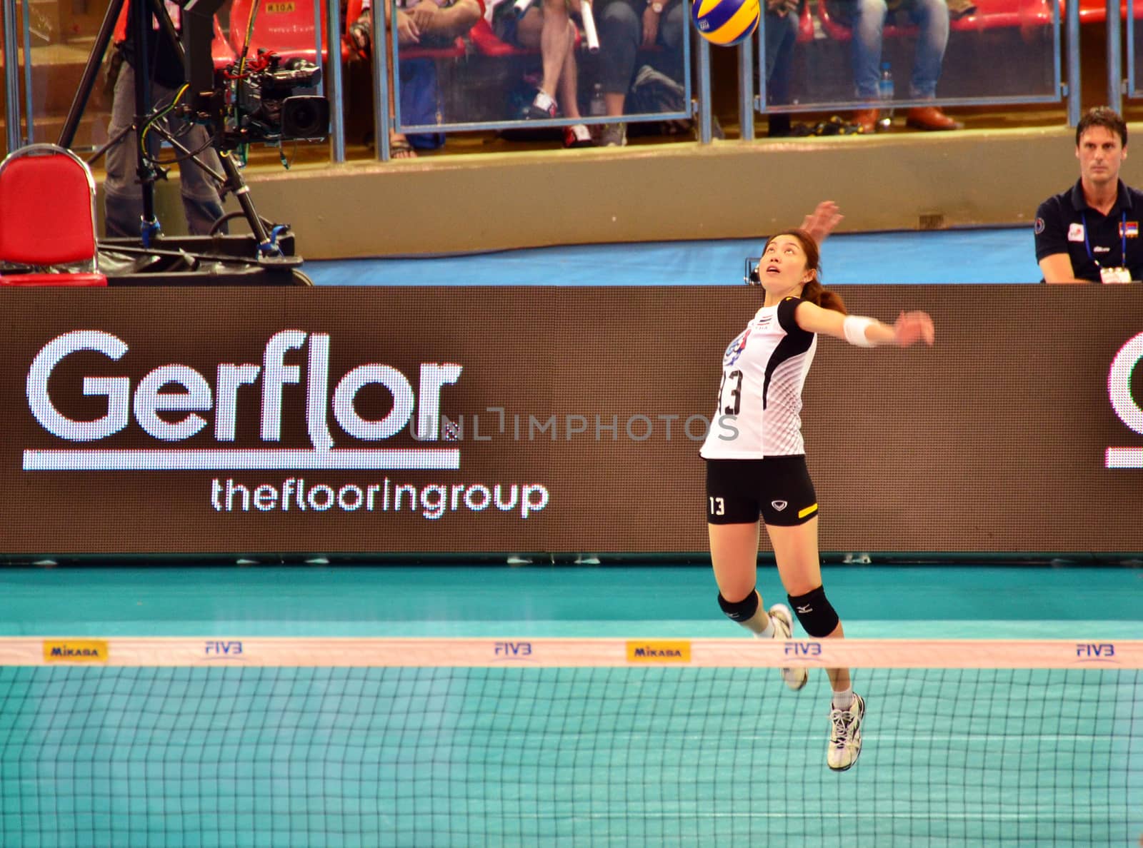 Bangkok, Thailand - July 3, 2015: Nootsara Tomkom #13 of Thailand serves the ball during the FIVB Volleyball World Grand Prix by siraanamwong