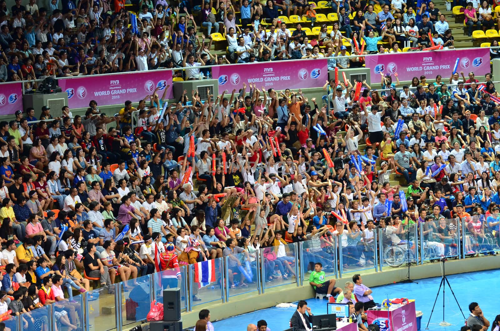 Bangkok, Thailand - July 3, 2015: Thai supporters playing wave at Indoor Stadium Huamark during the FIVB Volleyball World Grand Prix Thailand and Serbia on July 3, 2015 in Bangkok, Thailand.