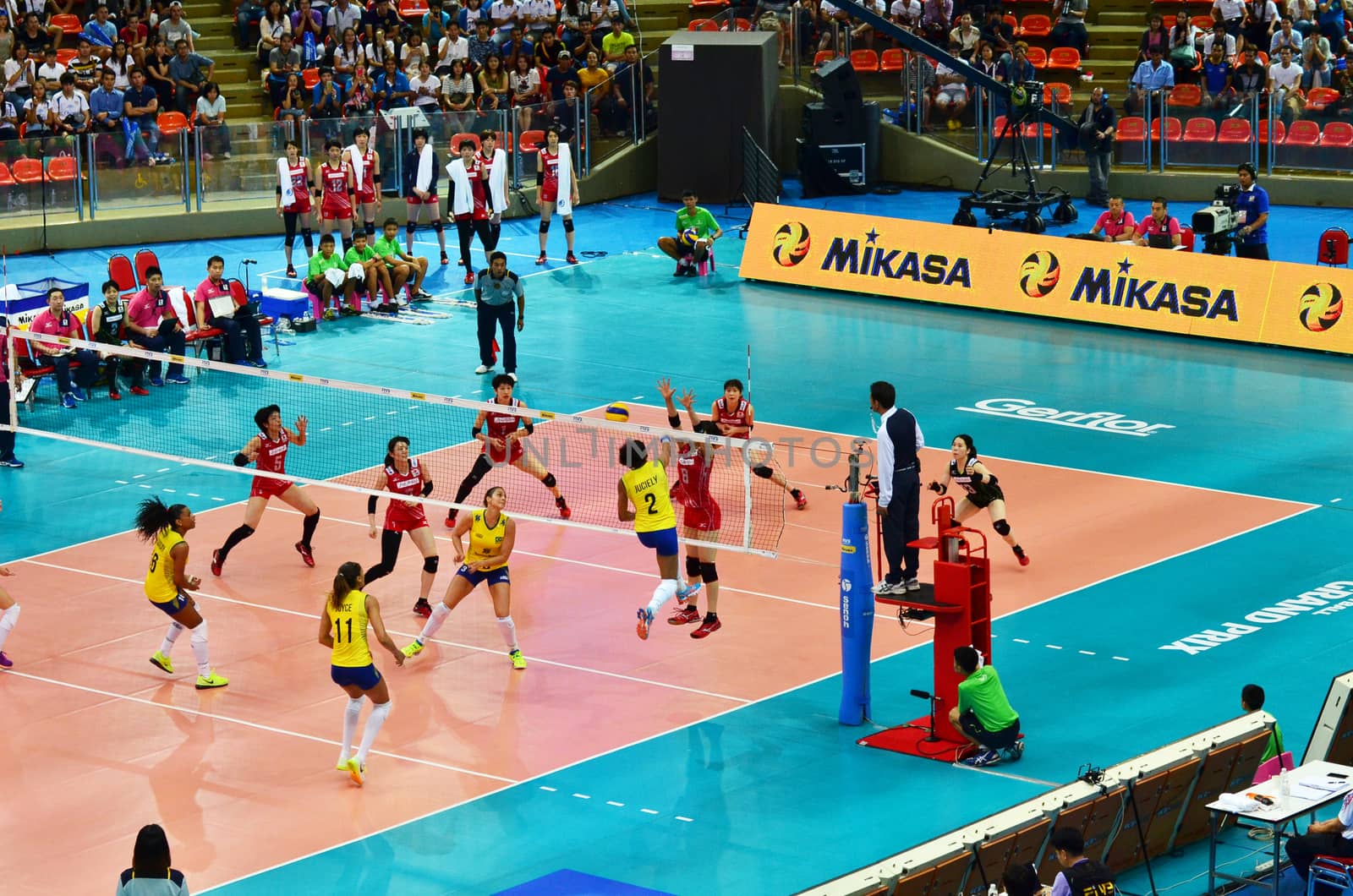 Bangkok, Thailand - July 3, 2015: Juciely #2 of Brazil spikes over Japanese block during the FIVB Volleyball World Grand Prix Brazil and Japan at Indoor Stadium Huamark on July 3, 2015 in Bangkok, Thailand.
