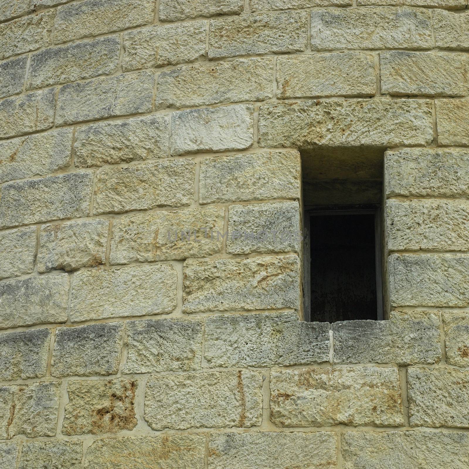 Deep cut out window in the side of a brick cylindrical castle