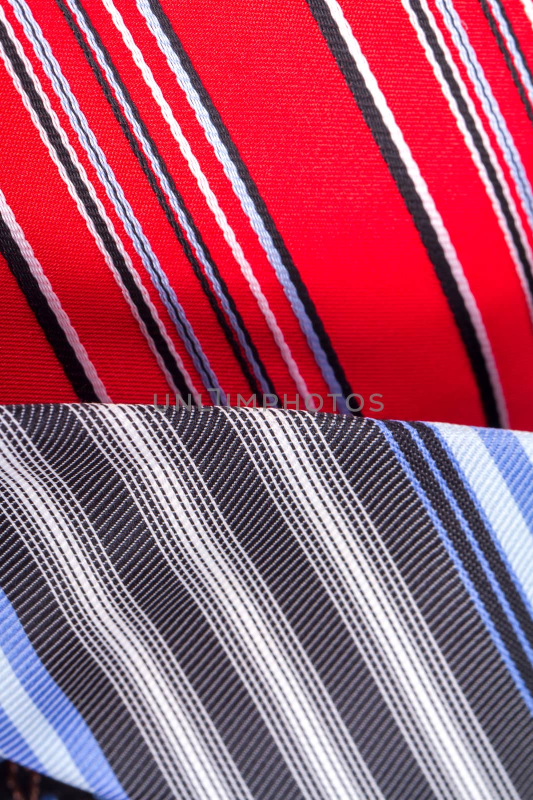 Close up detailed view of multicolored striped and checkered men ties as background.