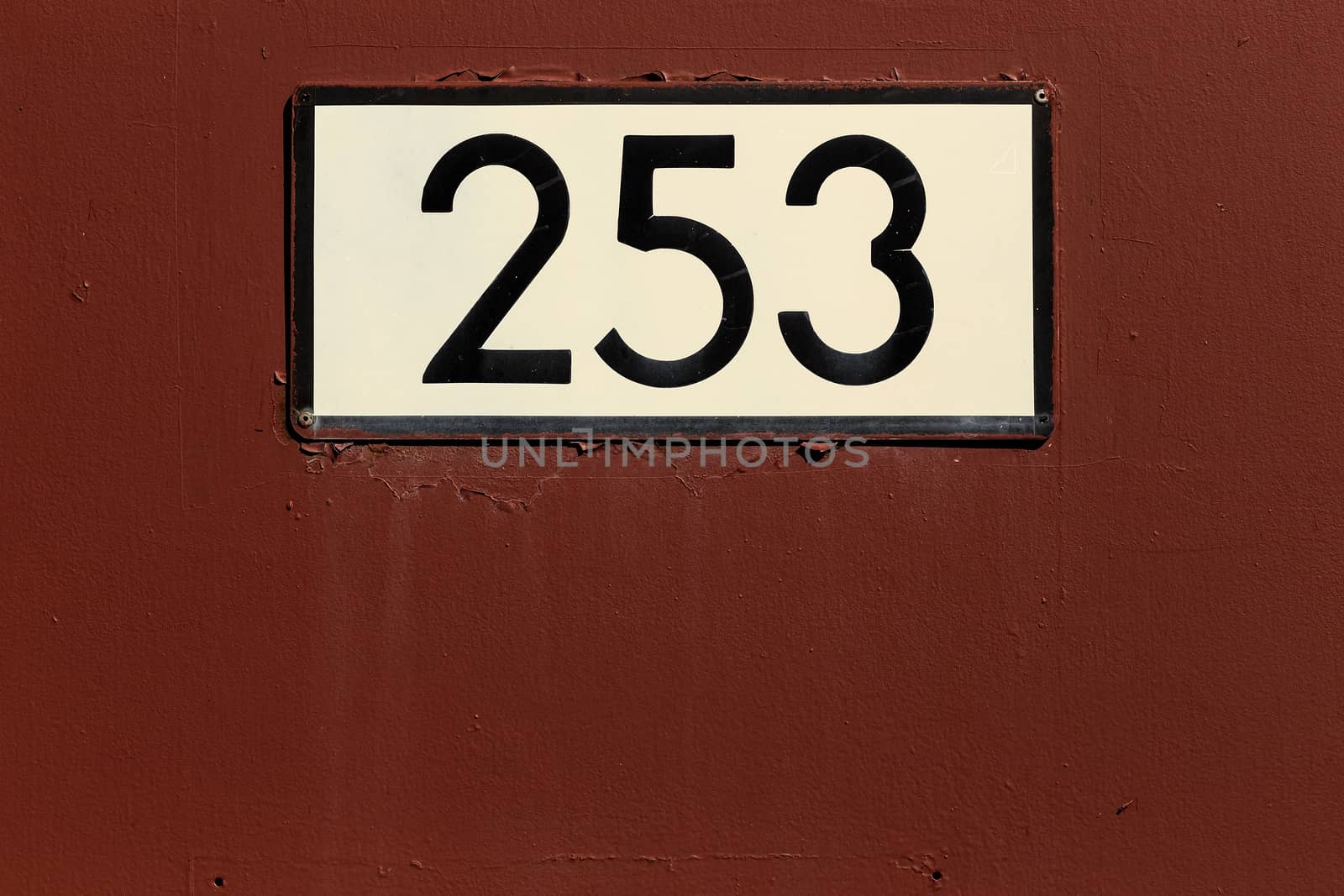 A steel door with a number sign on it.