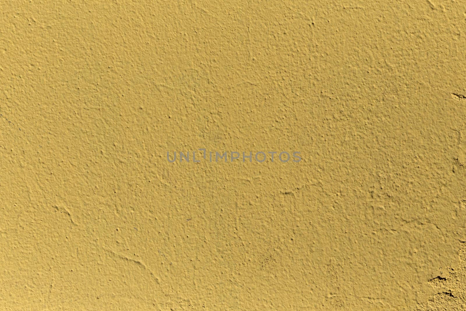 A grained yellow concrete wall with texture