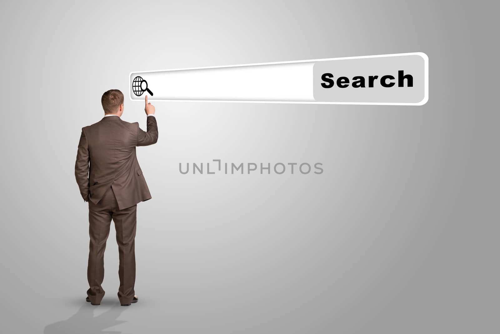 Businessman standing and pressing on browser on abstract grey background, rear view