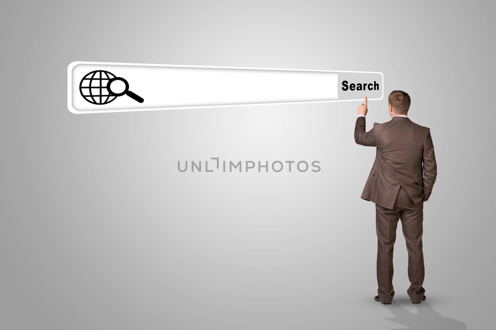 Businessman standing and pressing on empty browser on abstract grey background, rear view