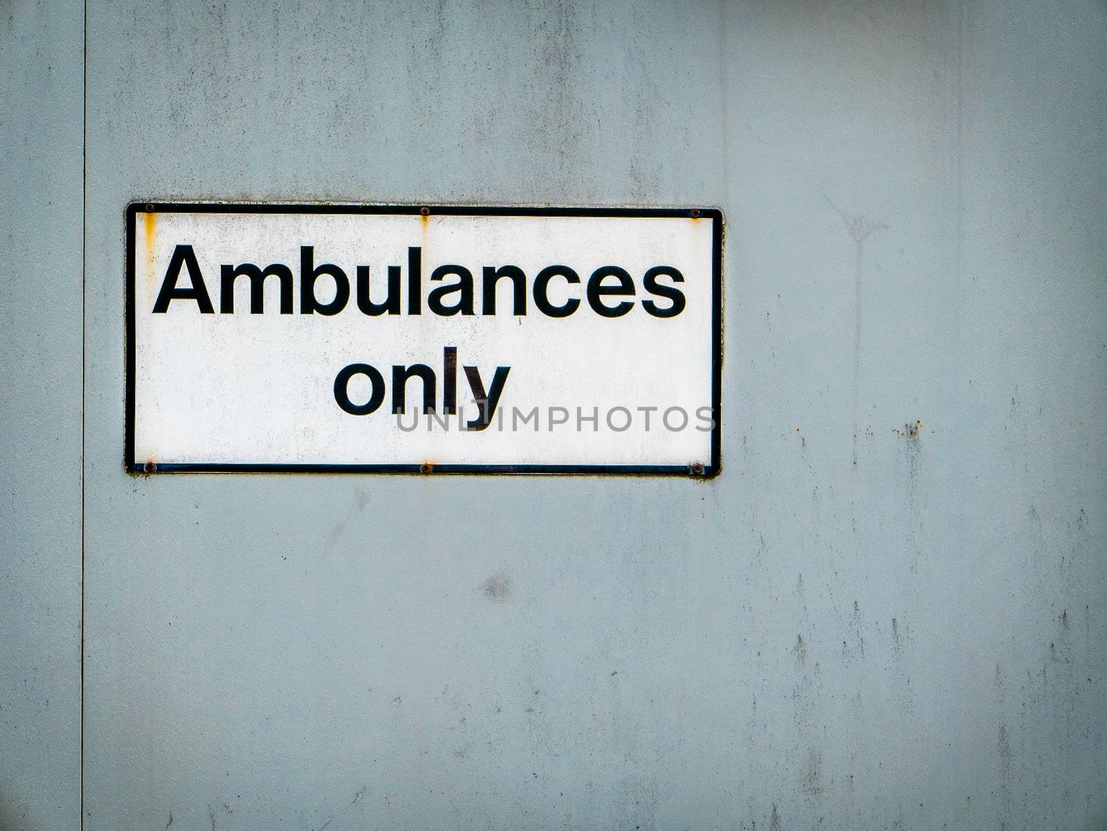 A Grungy Ambulances Only Sign At A Hospital Emergency Room