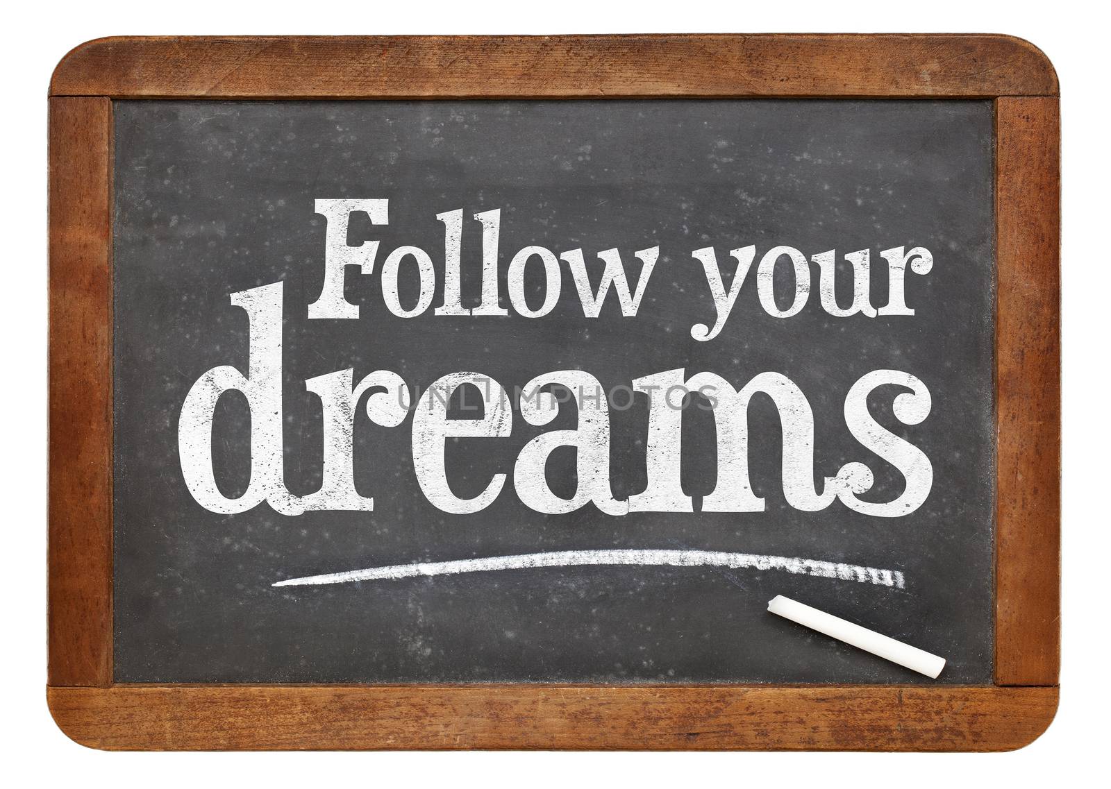 Follow your dreams - text on blackboard by PixelsAway