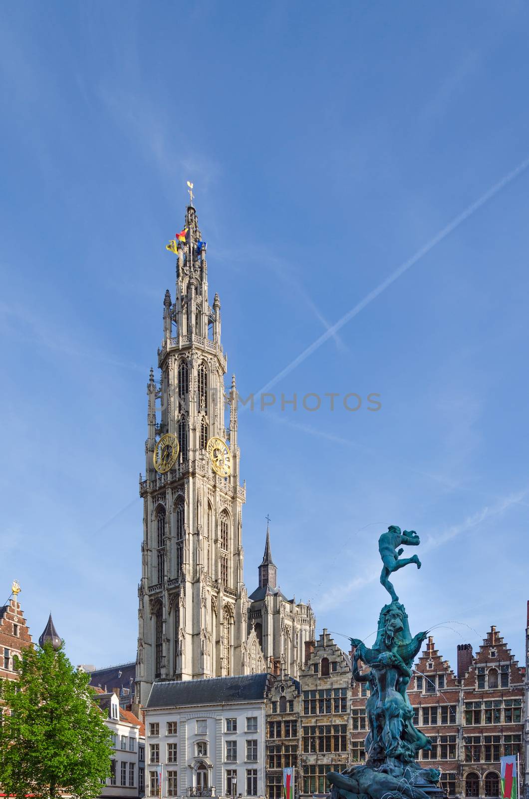 The Grand Place with the Statue of Brabo, throwing the giant's hand into the Scheldt River and the Cathedral of our Lady in Antwerp, Belgium. 