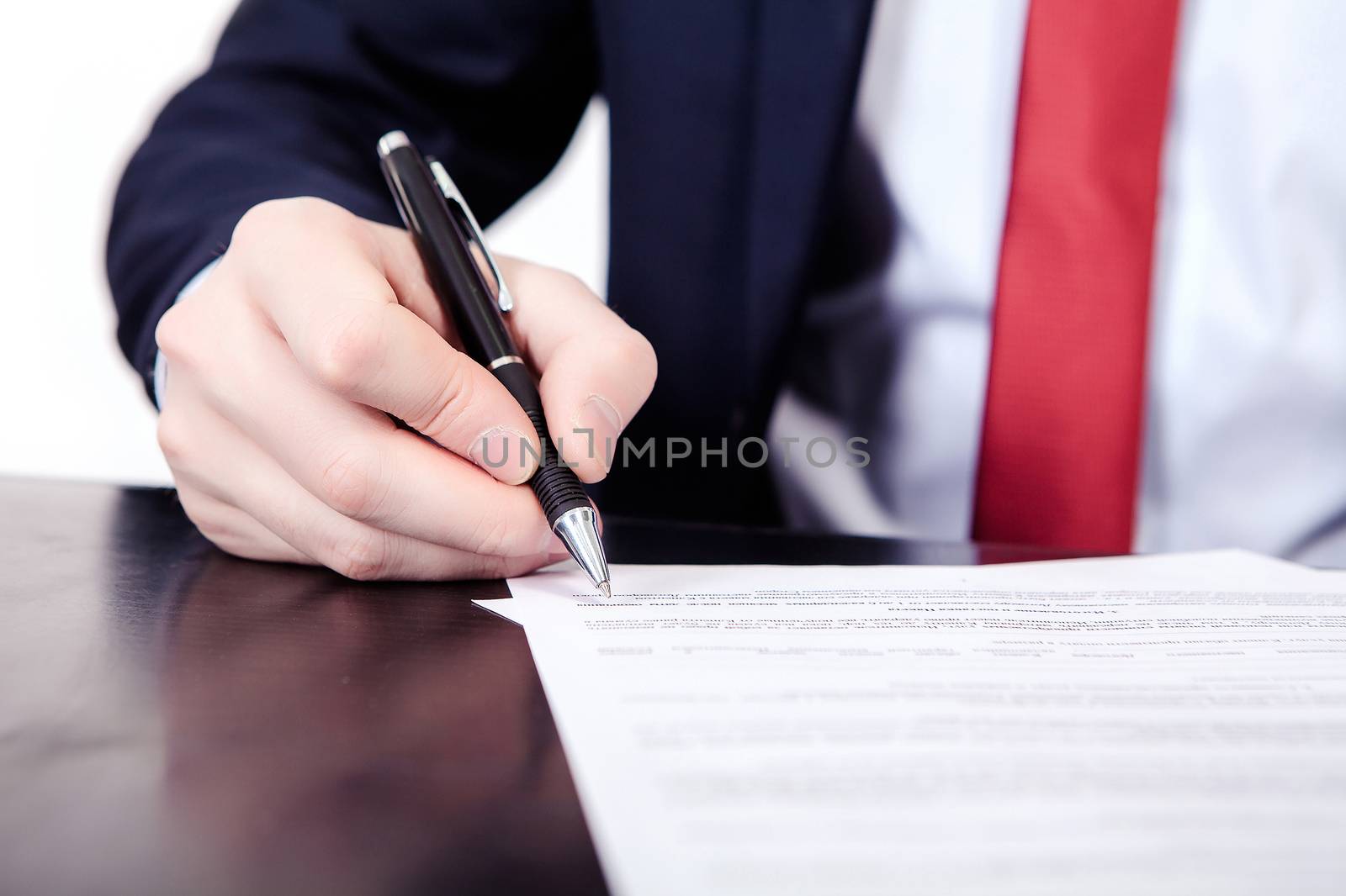 Businessman viewing the contract before signing Isolated on white background